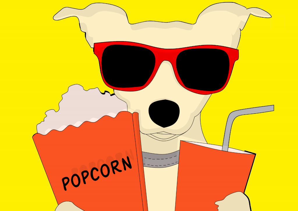 Ohren gespitzt, Pfoten ins Popcorn und los geht der Spaß beim winterlichen Kinoerlebnis. - Das Bild zeigt einen Comic-Hund mit Sonnenbrille. Er schaut uns an. In der Pfote links hält er eine Tüte Popcorn, rechts in der anderen Pfote einen becher mit Strohhalm.