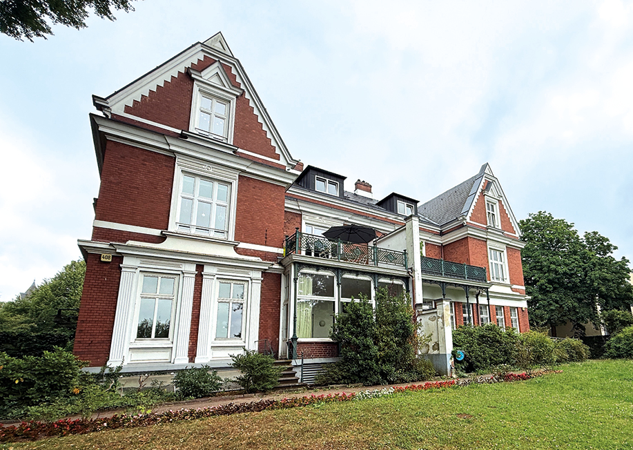 Das Gebäude an der Elbchaussee 408 war früher ein Doppelgemeindehaus, was sich außen noch heute an den äußeren Querhäusern und einer Trennung zeigt.